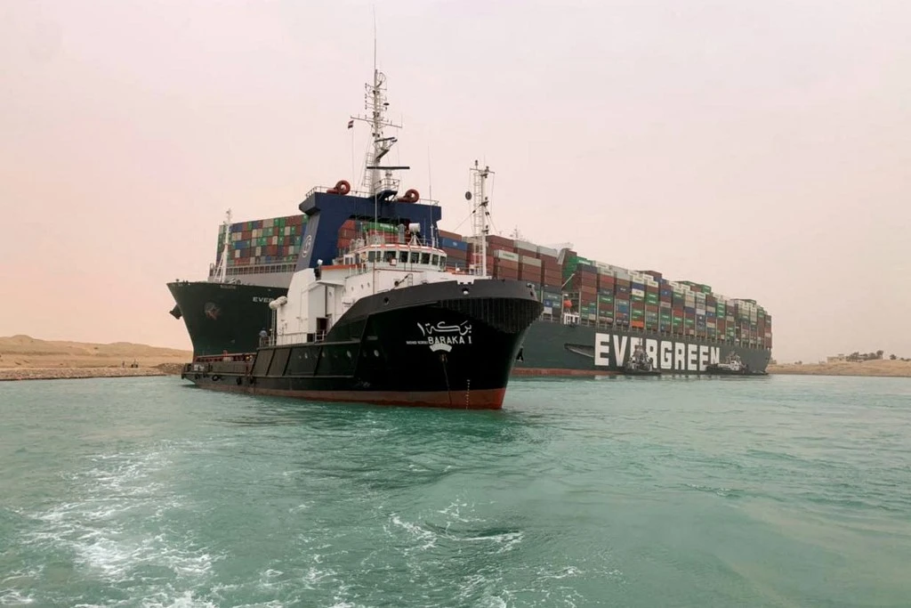 Handout picture released by the Suez Canal Authority on March 24, 2021 shows the MV Ever Given (Evergreen) lodged sideways and impeding all traffic across the waterway of Egypt’s Suez Canal. (File/AFP)