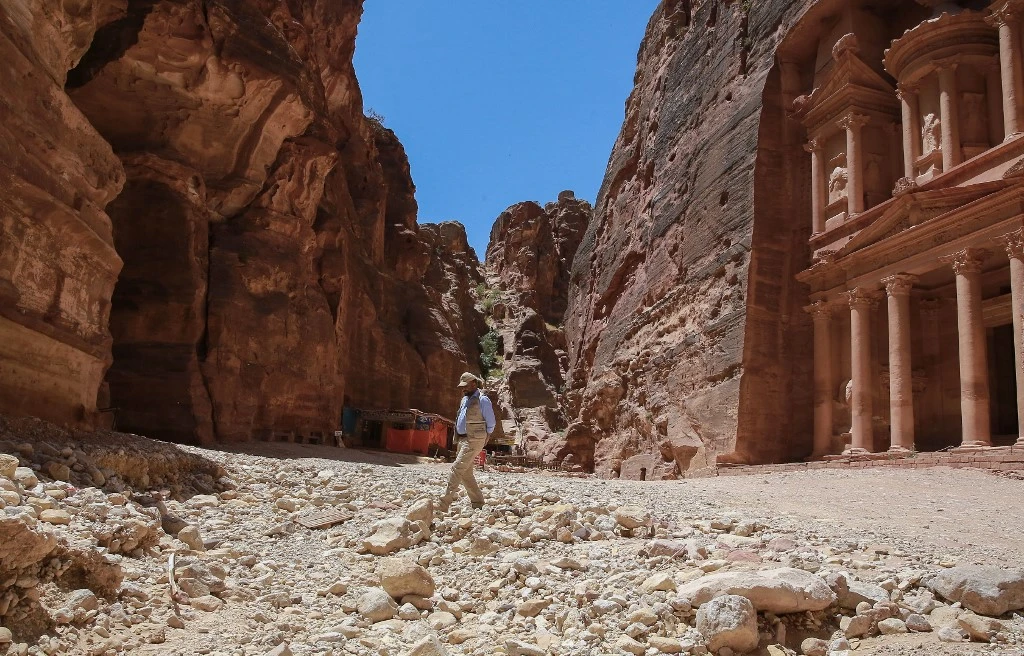 Tourism, which was badly hurt due to the pandemic, is one of the major sources of revenue for Jordan. Above, the ancient city of Petra empty of tourists. (AFP)