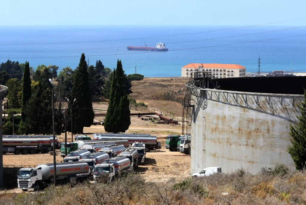 Tanker trucks filled with fuel offered by Iraq wait to empty their content at the oil refinery of Zahrani, near the southerm Lebanese city of Sidon (Saida) on Aug. 20, 2020. (File/AFP)