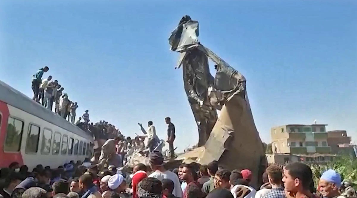 Egypt buries train crash dead, toll revised to 19