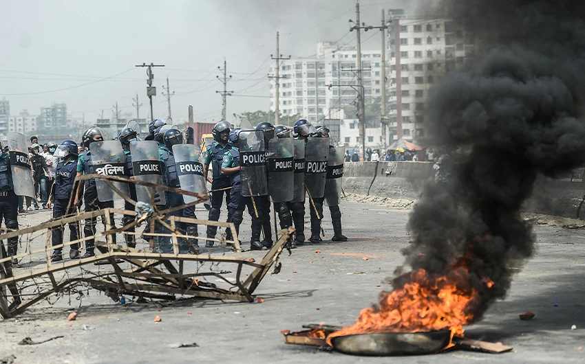 Police personnel march towards protestor as they block a road during a nationwide strike following deadly clashes with police over Indian Prime Minister Narendra Modi’s visit, in Narayanganj, on March 28, 2021. (AFP)