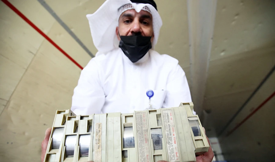 Employee at the Kuwaiti Information Ministry Essam al-Said inspects boxes in the back of a truck containing Kuwaiti archives seized during the Iraqi invasion of the Gulf emirate in 1990. (AFP)
