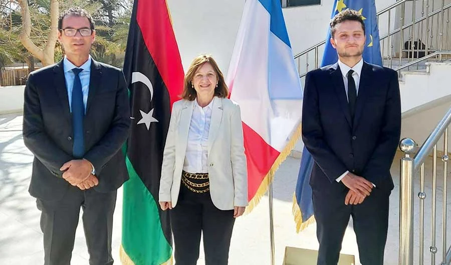 A handout photo obtained from the French Embassy in Libya shows the ambassador of France in Tripoli, Béatrice le Fraper du Hellen (C), posing for a picture with two unidentified officials in Tripoli. (AFP)