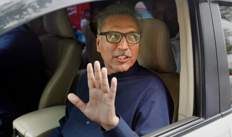 In this Aug. 27, 2018 file photo, Arif Alvi, then a lawmaker from Imran Khan's Tehreek-e-Insaf ruling party waves to media after filing his nomination papers in the presidential election, in Islamabad, Pakistan. (AP)