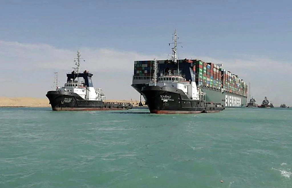 Picture released by Egypt’s Suez Canal Authority on March 29, 2021, shows a tugboat pulling the Panama-flagged MV ‘Ever Given’ container ship after it was fully dislodged from the banks of the Suez. (File/AFP)