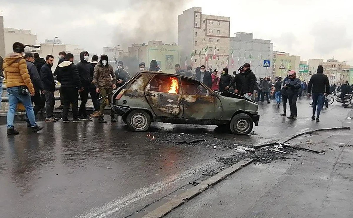 Iranian protesters gather around a burning car during a demonstration against an increase in gasoline prices in the capital Tehran, on November 16, 2019. (AFP/File Photo)