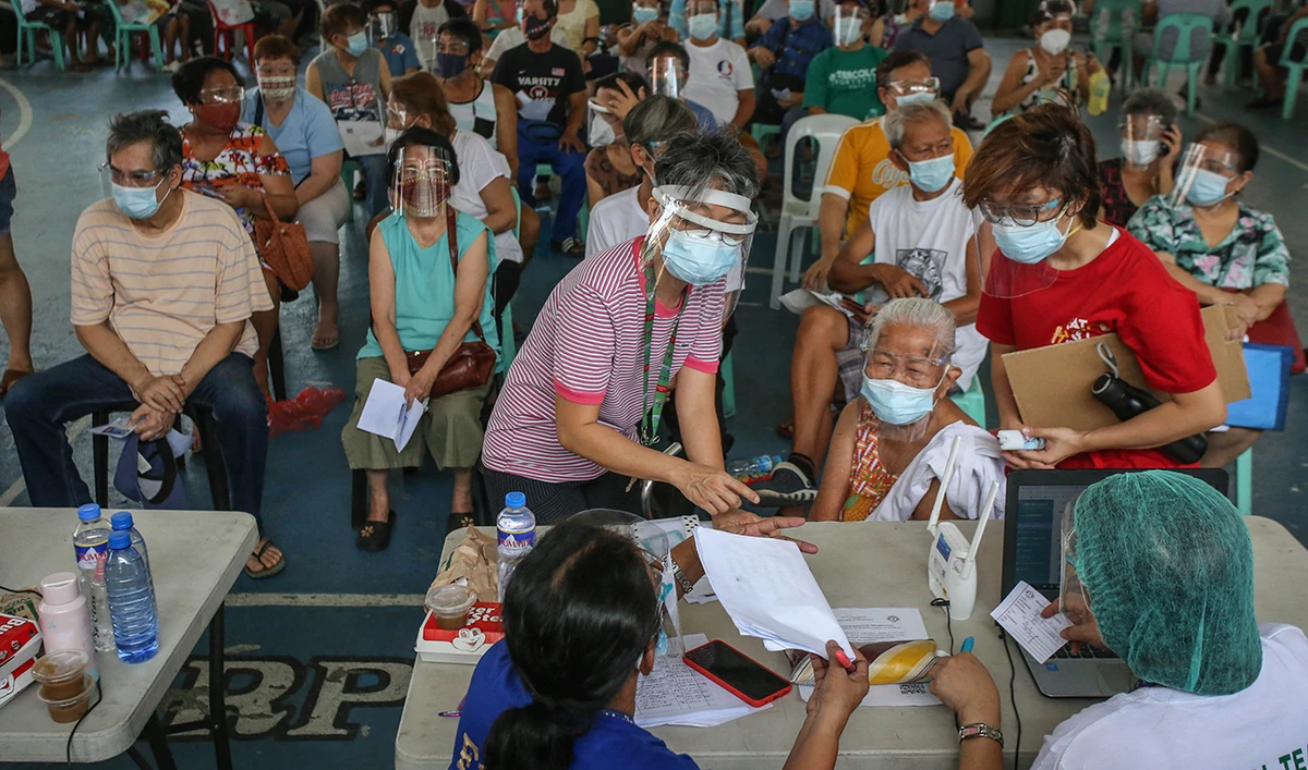 Elderly residents wait for their turn to get the AstraZeneca vaccine after the government imposed a stricter lockdown to cope with a surge in infections. (AFP)