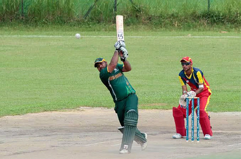 Saudi Arabia's batsman, Shahbaz Rasheed's cameo (in green) plays a shot against Bahrain in Asian Cricket Council Elite League in Singapore on June 10, 2014. (Photo courtesy: ESPN Cricinfo)