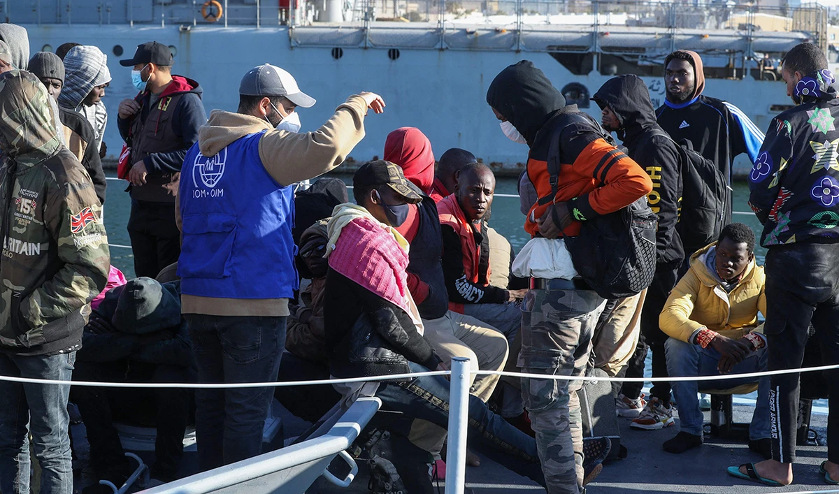 Migrants arrive at a naval base in the Libyan capital of Tripoli on March 31, 2021, after the coastguard intercepted an inflatable boat carrying 138 Europe-bound migrants off its west coast. (AFP)