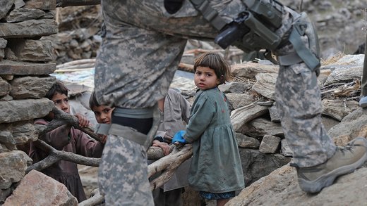 A U.S. soldier walks by children in northeastern Afghanistan. (AFP)