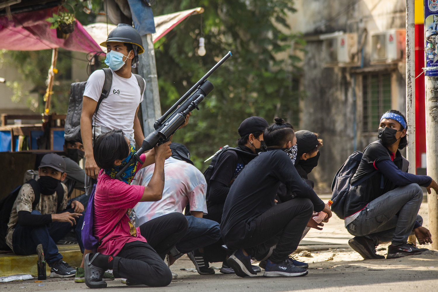 Anti-coup protesters aim to defend themselves with homemade air rifles during a demonstration against the military coup in Yangon, Myanmar, Saturday, April 3, 2021. (AP)