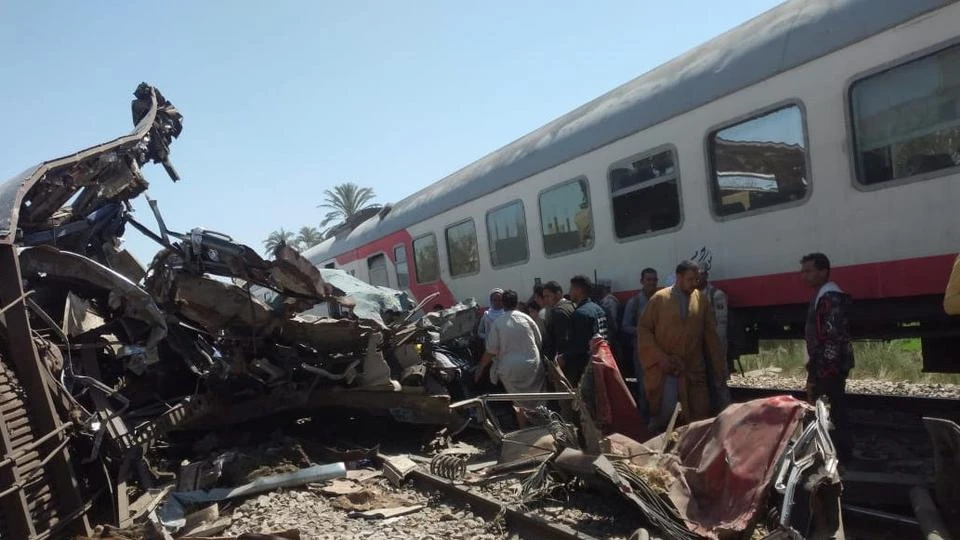 People inspect the damage after two trains collided near the city of Sohag, Egypt, March 26, 2021. (Reuters)