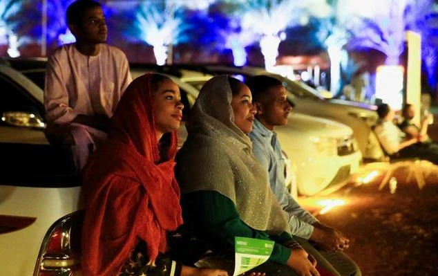 People watch a movie in a drive through cinema in Sudan. The country is gradually opening up to foreign investment. (Reuters)