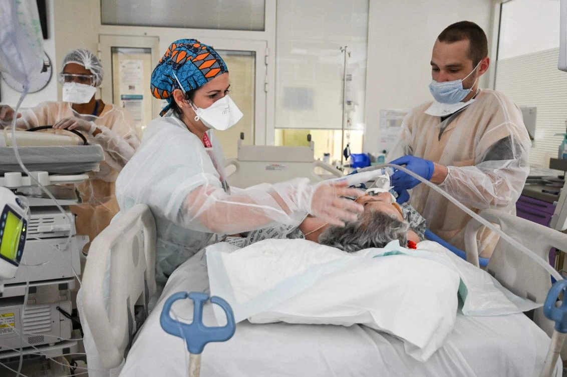 Medical staff give medications to Covid-19 patient at the intensive care unit of the Andre-Gregoire intercommunal hospital in outskirts of Paris as France adopted new measures to fight coronavirus spread. (AFP)