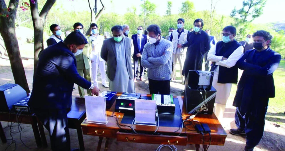 Pakistan’s Prime Minister Imran Khan, right first row, receives briefing about e-voting in Islamabad on Wednesday. (Photo courtesy: Pakistan Press Information Department)