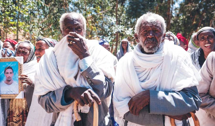 People mourn the victims of a massacre allegedly perpetrated by Eritrean soldiers in the village of Dengolat, north of Mekele, the capital of Tigray. (File/AFP)