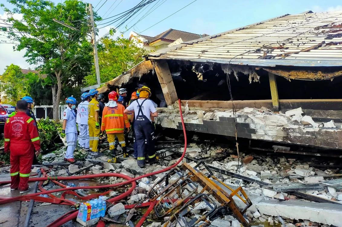 Rescue workers look at the wreckage of a building after it collapsed in Bangkok. (Poh Teck Tung Foundation via AFP)