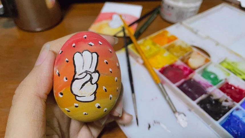An Easter egg is painted with a three-finger salute as part of a campaign for an Easter egg protest against military rule in Yangon, Myanmar on April 3, 2021. (Reuters)