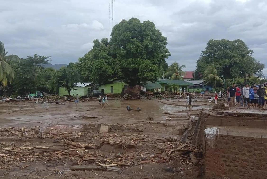 Residents inspect the damage at a village hit by flash flood in East Flores, Indonesia, Sunday, April 4, 2021. (AP)
