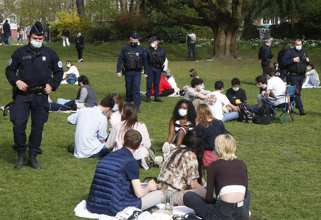 Policemen patrolling between people enjoying the sun in northern France, as authorities started on Sunday investigating accusations that ministers dined in secret restaurants in violation of pandemic restrictions. (AP)