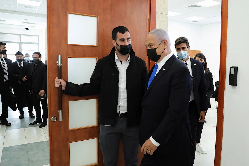 Israeli Prime Minister Benjamin Netanyahu leaves the courtroom during a hearing as his corruption trial resumes, at Jerusalem's District Court on Monday. (Reuters)