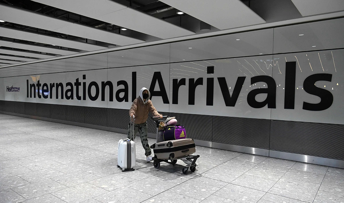 A passenger walks through the arrivals hall at London’s Heathrow Airport. (AFP)