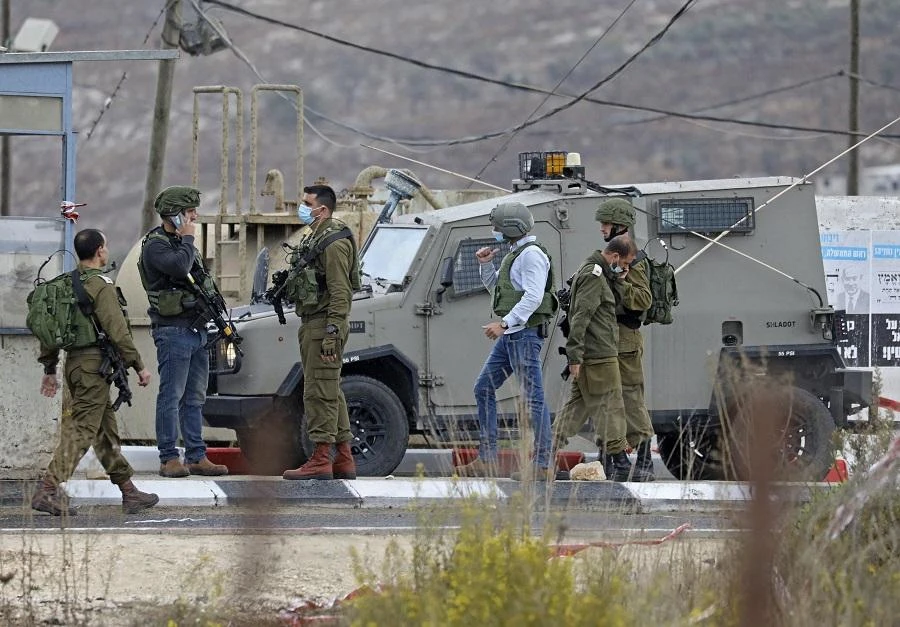 Israeli soldiers gather at a checkpoint near Nablus in the occupied West Bank where a Palestinian who shot at Israeli troops on November 4, 2020. (File/AFP)