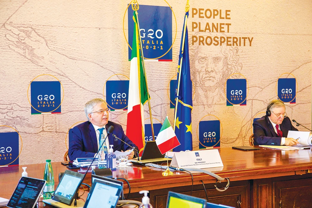 Italy’s Economy Minister Daniele Franco, left, speaks during the 2nd G20 Finance Ministers and Central Bank Governors meeting via videoconferencing in Rome. (AFP)