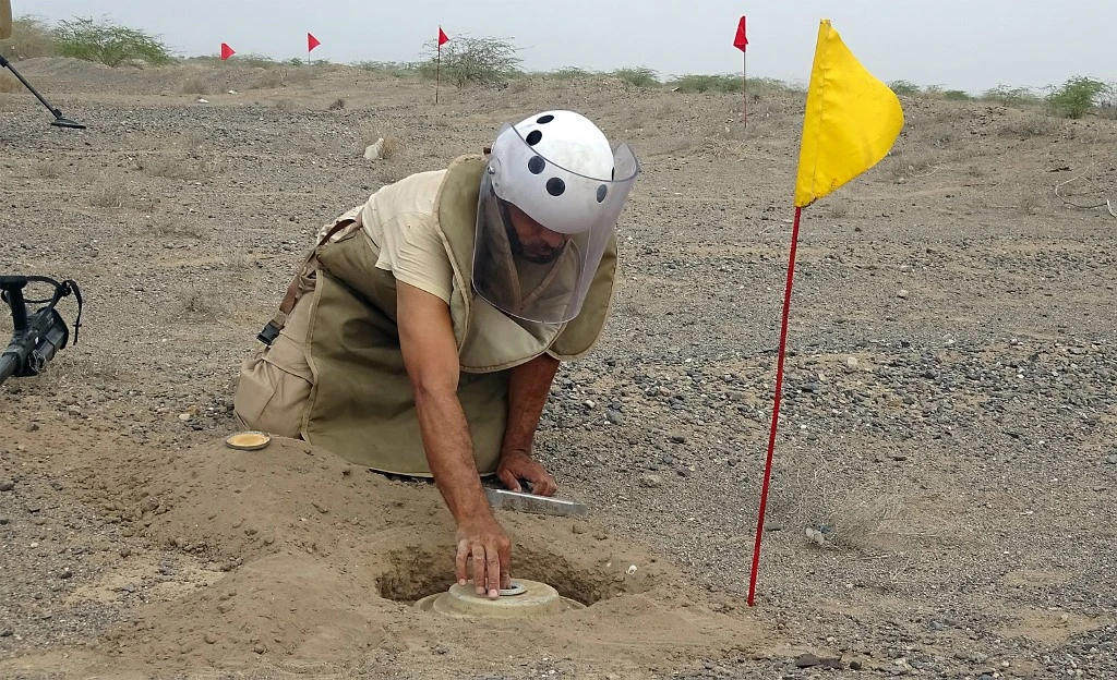 Above, a member of Yemen’s demining team searches for land mines in the western province of Hodeida on March 1, 2021. (AFP)