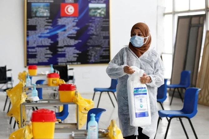 Health worker prepares for coronavirus vaccination in Tunisia that announced extended night curfew 7pm-5am ahead of Ramadan till April 30. (Reuters)