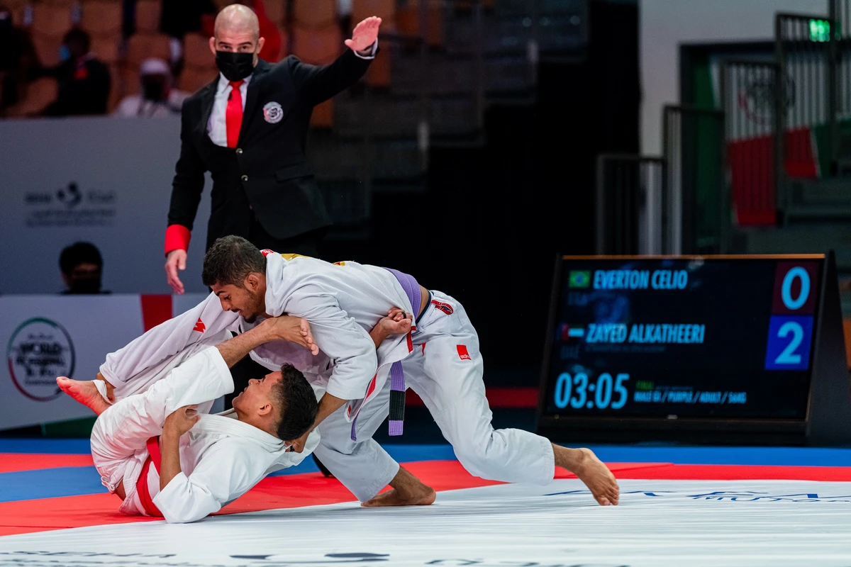 The UAE’s Zayed Al-Katheiri, right, clinched gold against Brazil’s Everton Celio in the adult purple belt (56-kg) division. (UAEJJF)