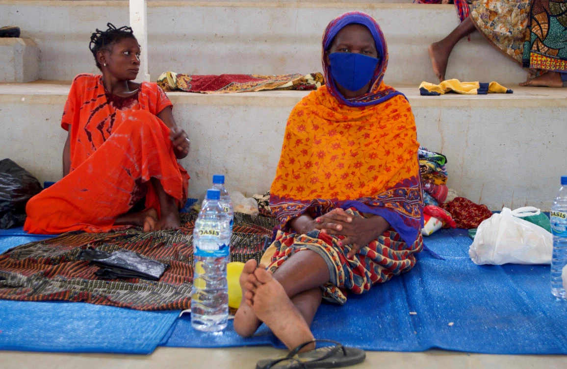 Displaced women sit on mats after fleeing an attack claimed by Daesh-linked insurgents on the town of Palma, at a displacement center in Pemba, Mozambique, April 2, 2021. (Reuters)
