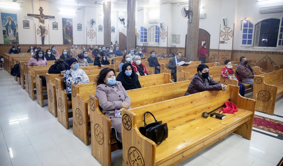 Egyptian Christians worshippers attend Christmas Eve mass at the Coptic Catholic St. Mark Church in Minya city, in Cairo on January 6, 2021. (AFP)