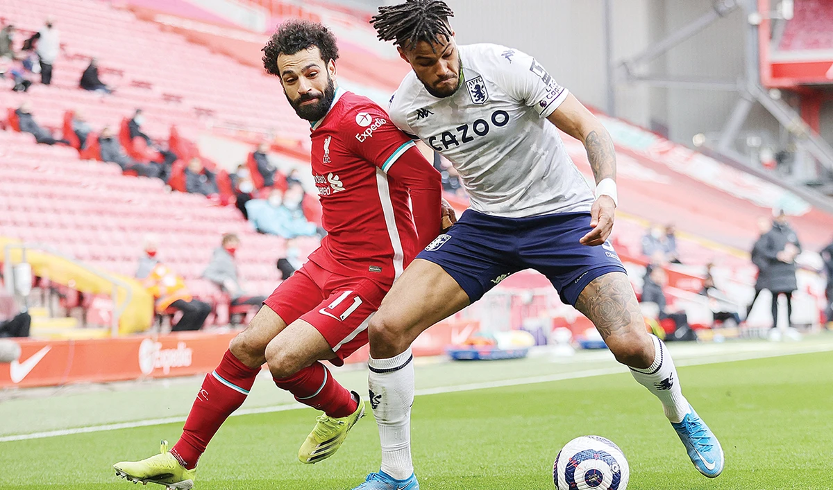 Aston Villa’s defender Tyrone Mings vies with Liverpool’s midfielder Mo Salah during Saturday’s match. (AFP)