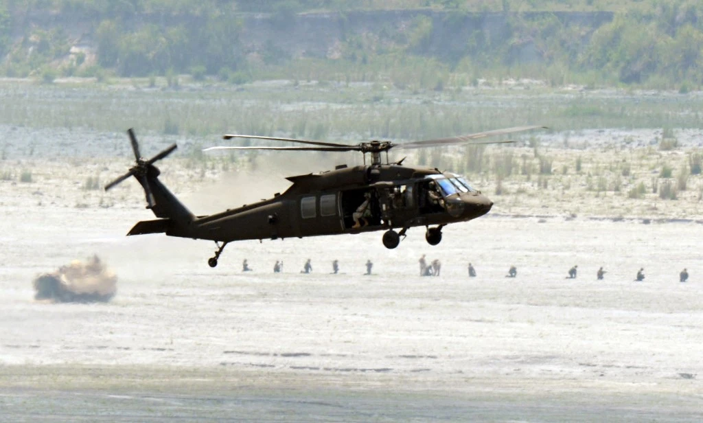 A US Army UH-60 Black Hawk helicopter prepares to land near an assault amphibious vehicle during the joint US and Philippine troops live fire exercise on April 30, 2015. (AFP)