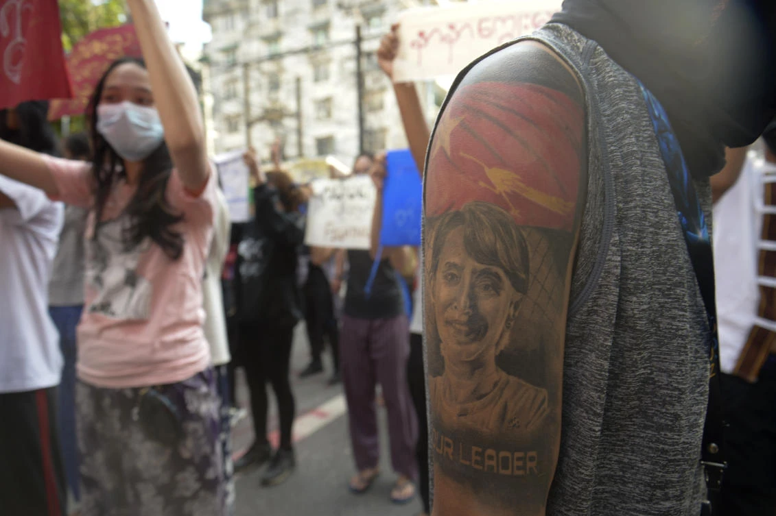 A protester with an image of ousted Myanmar leader Aung San Suu Kyi on the arm joins anti-coup protest march in Yangon, Myanmar, Saturday, April 10, 2021. (AP Photo)