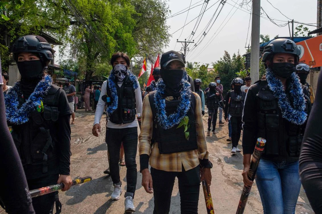 This photo taken and received courtesy of an anonymous source on April 13, 2021 shows protesters carrying fireworks while taking part in a demonstration against the military coup in Mandalay during the Myanmar New Year festival of Thingyan. (AFP)