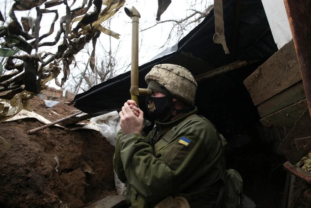 A Ukrainian serviceman stands guard at a position on the frontline with Russia backed separatists near small city of Marinka, Donetsk region on April 12, 2021. (File/AFP)