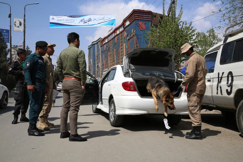 Afghan police check a vehicle at a checkpoint in Kabul on Wednesday. (AFP)