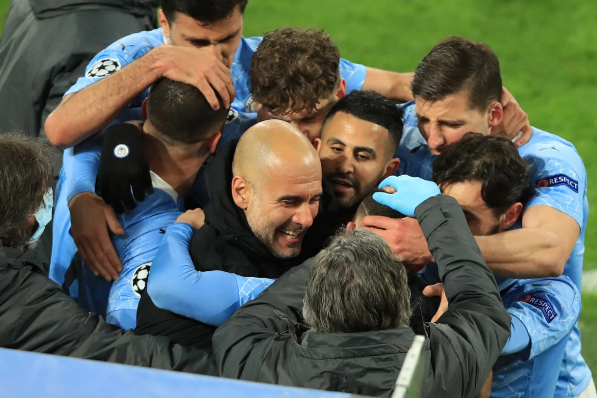 The Manchester City team celebrate after scoring the 1-2 goal during their UEFA Champions League quarter-final second leg football match with BVB Borussia Dortmund in Germany on April 14, 2021. (AFP / POOL / WOLFGANG RATTAY)