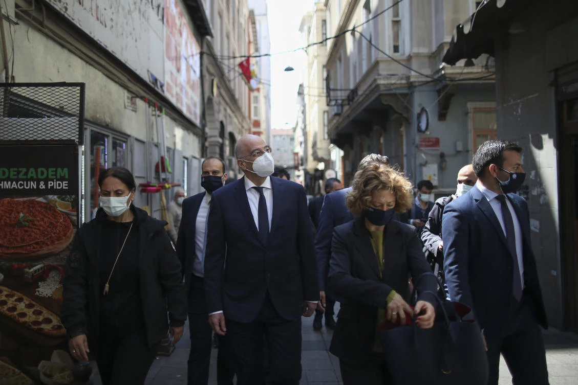 Greek Foreign Minister Nikos Dendias walks to visit an old Greek school in Istanbul. Turkish President on Friday robustly defended his foreign minister after trading barbs Dendias. (AP)
