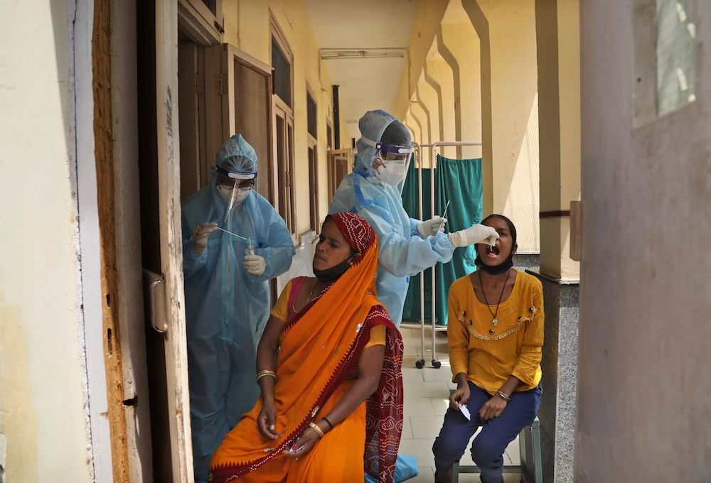 Health workers collect swab samples to test for COVID-19 in New Delhi, India, Friday, April 16, 2021. (AP Photo)