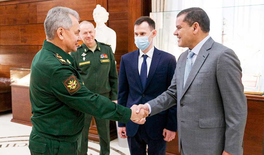 Russian Defense Minister Sergei Shoigu shakes hands with Libyan Prime Minister of the Government of National Unity Abdul Hamid Dbeibah in Moscow. (AP)
