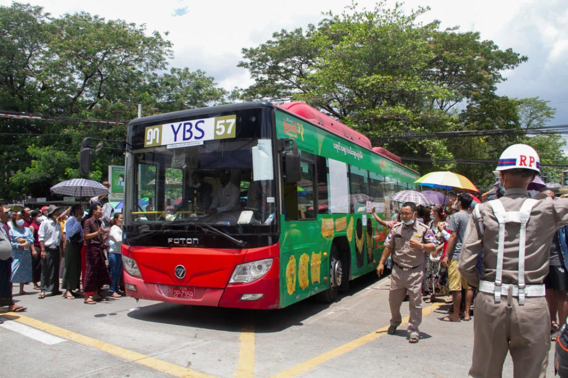 Relatives and friends gather around a bus carrying prisoners outside the Insein Prison in Yangon, Myanmar, as the military junta released 23,184 prisoners from jails across the country on Saturday under a New Year amnesty. (REUTERS)