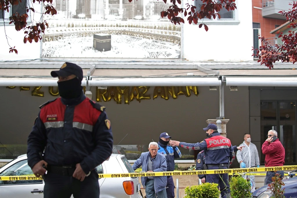Albanian police officers are seen in front of Dine Hoxha mosque after a knife attack, in Tirana on Monday. (REUTERS)