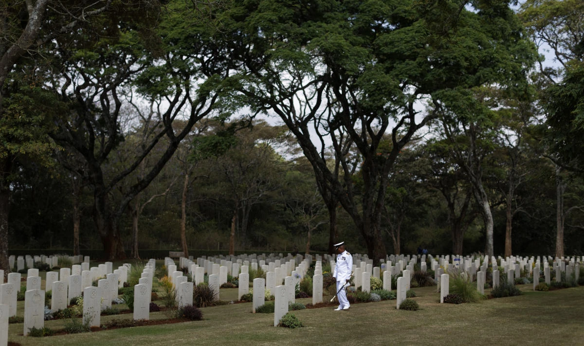 A Kenyan naval officer walks amongst the graves before observing Remembrance Sunday at the Nairobi War Cemetery in Kenya. (AP)