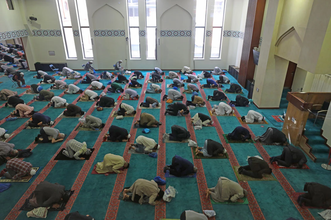 Worshippers pray at the East London Mosque & London Muslim Center in London, England. (Supplied)