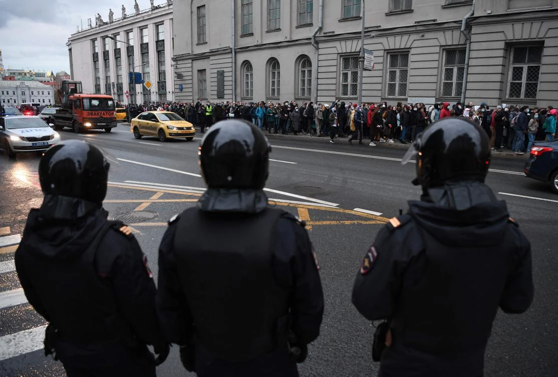 Russian police officers look on as opposition supporters walk during a rally in Moscow in support of jailed Kremlin critic Alexei Navalny, who announced he’s ending his hunger strike on Friday. (AFP)