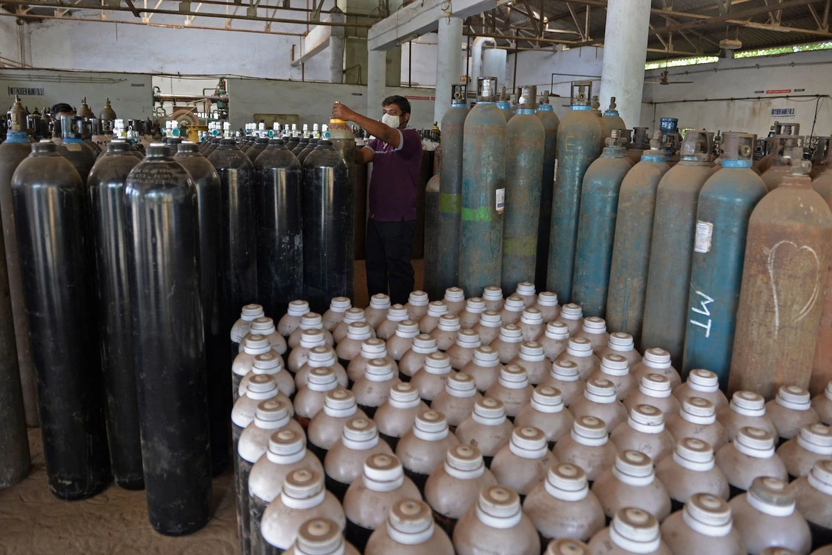 A worker arranges medical oxygen cylinders to be transported to hospitals amid Covid-19 coronavirus pandemic at a facility on the outskirts of Chennai on April 24, 2021. (AFP)