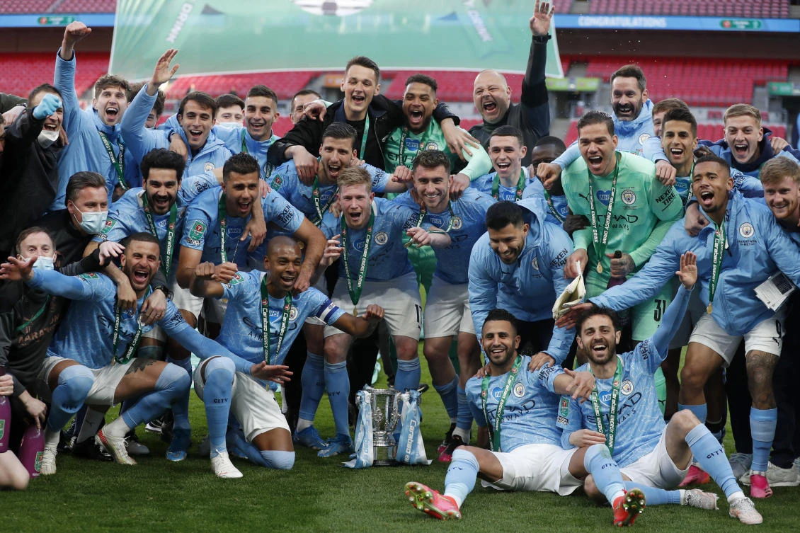 Manchester City players celebrate with the trophy at the end of the English League Cup final match between Manchester City and Tottenham Hotspur at Wembley stadium. (AP)